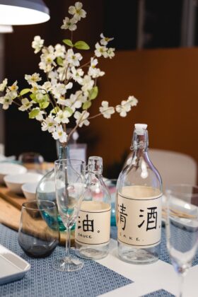sake bottles next to a flower